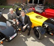 Paul Keeling, of UKTI West Midlands (back), and Julian Turner, of Westfield Sportscars Ltd, with some of the hand-built luxury vehicles.